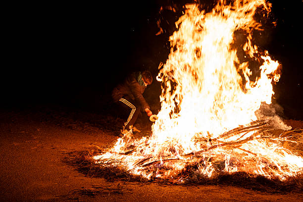 Yekaterinburg, Russia - March 2, 2025: Traditional ritual of burning Maslenitsa effigy during festival marking end of winter. Crowd gathers to witness symbolic event, celebrating heritage and change.