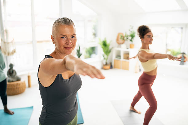 istock Diverse group yoga practice in a serene and naturally lit fitness studio setting 2230097205