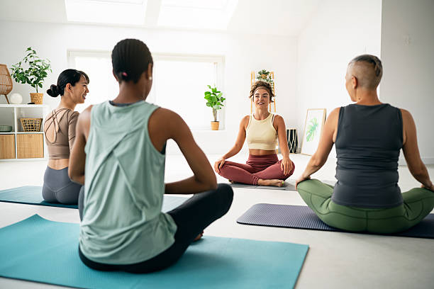 istock Relaxed Diverse Group Doing Yoga in a Bright, Peaceful Environment 2230097888