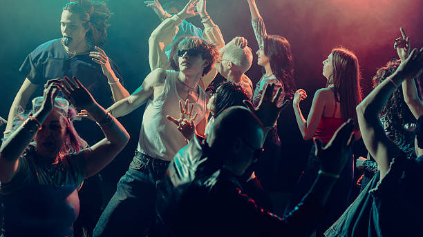 istock A lively dance floor with diverse people enjoying a party under colorful lighting. 2230098544