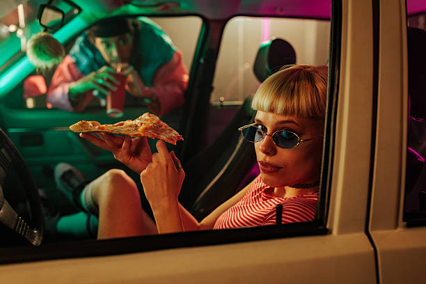 istock Retro couple eating in car. 2230103142