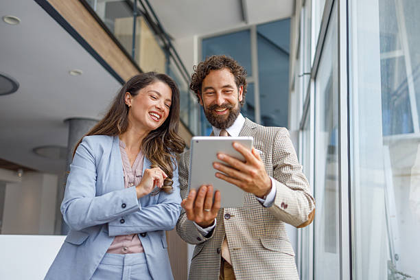 istock Business people smiling and using digital tablet in office 2230103327