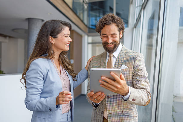 istock Business colleagues smiling and using digital tablet in office 2230103413