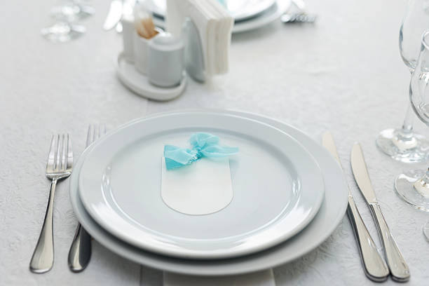 istock Elegant table setting with an empty menu card for a wedding or special event. 2230107148