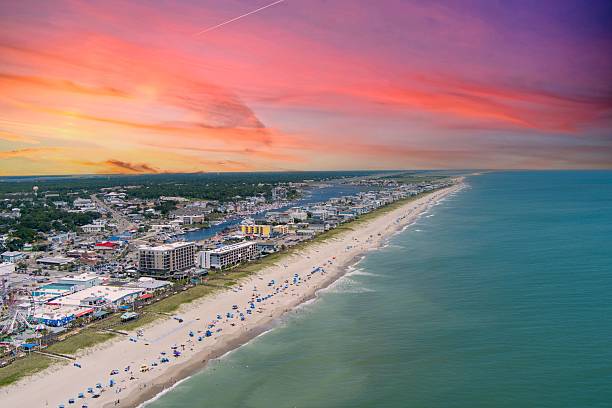 istock Vibrant beach town at sunset with colorful skies. 2230107896