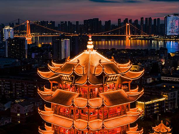 istock Yellow Crane Tower at night with city skyline. 2230108172