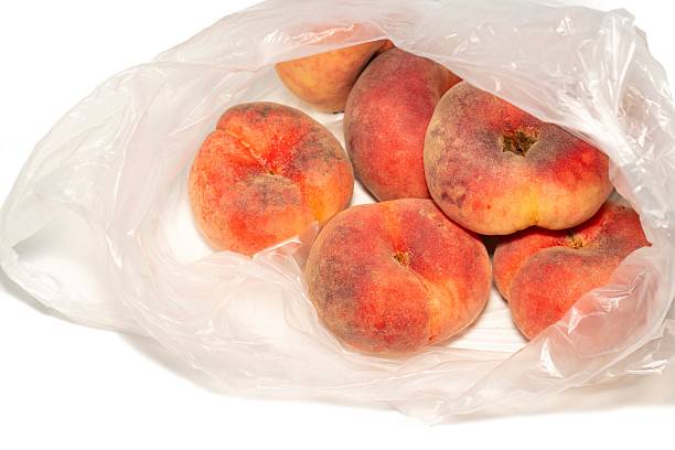 istock fresh organic flat peaches in a transparent plastic bag 2230109593