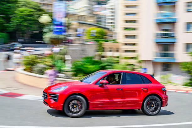Porsche Macan SUV driving on the street of Monte Carlo in the Grand Hotel Hairpin of the Monaco race track.