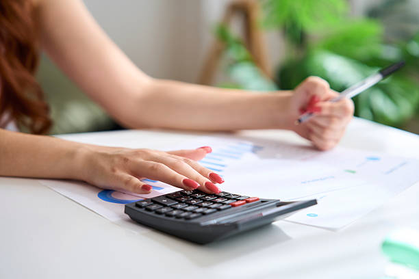 istock Businesswoman calculating expenses and analyzing charts in home office 2230113321
