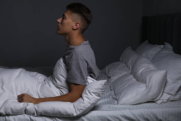 istock Young man suffering from sleepwalking on bed at home 2230114453