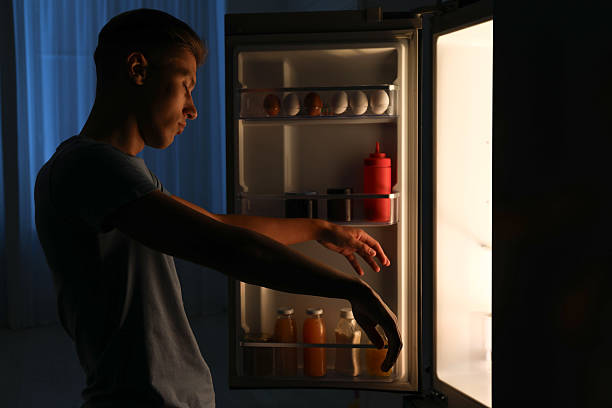 istock Young man suffering from sleepwalking near fridge at home 2230114557