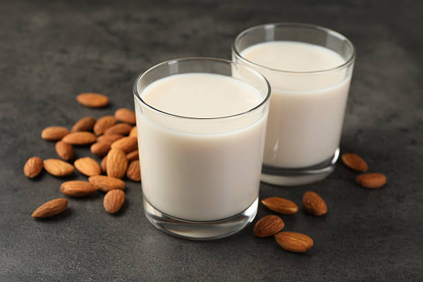 istock Fresh almond milk in glasses and nuts on dark grey table, closeup 2230115233