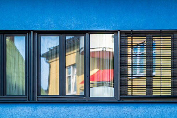 istock Modern glass facade reflects neighboring buildings in urban setting during daylight hours 2230115952