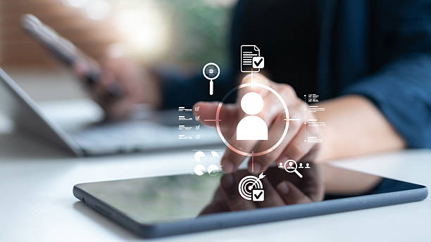 istock HR professional using a tablet to manage candidate profiles with verification and target icons, representing recruitment technology, talent acquisition, and digital HR systems. 2230116100