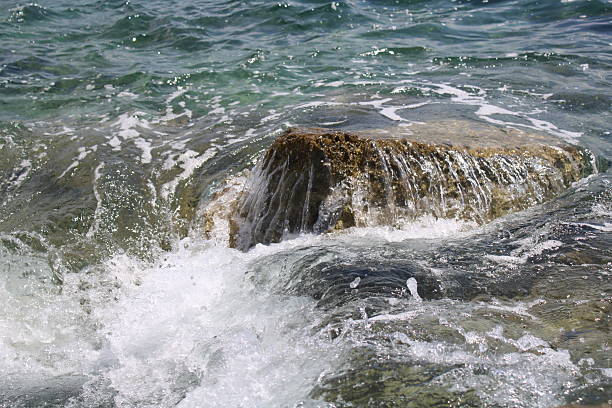 Wate-washed rock on a beach in Porec, Croatia