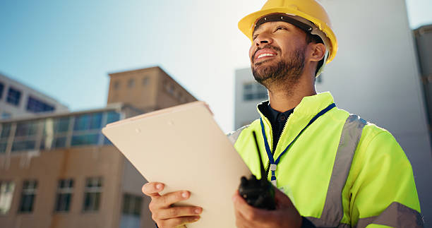 istock Happy man, contractor and city with folder for construction, building or industrial project design. Male person, architect or civil engineer with smile, document or permit below for architecture site 2230118057