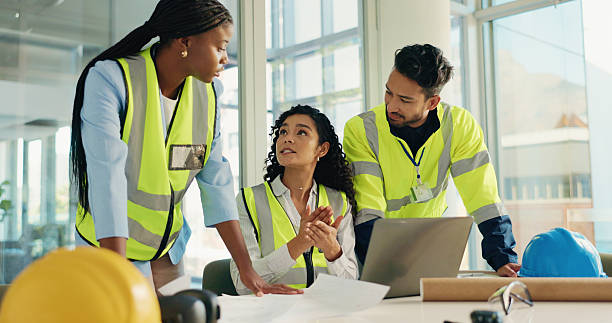 istock Laptop, talking and architect with people in office for engineer project, planning or contractor. Construction briefing, building and cad floorplan with employees for research and digital blueprint 2230118098