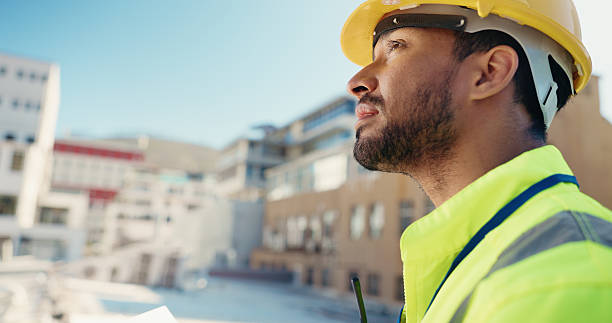 istock Thinking, engineering and contractor with man on rooftop for  inspection, building project or idea. Construction site, reflection and architect with person in city for renovation and infrastructure 2230118139