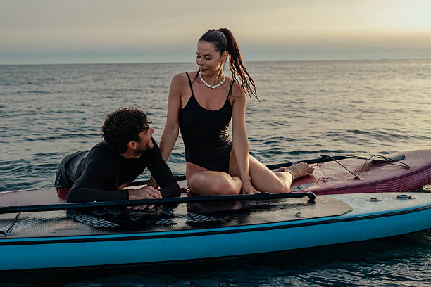 istock Couple relaxing on two paddleboards 2230118405