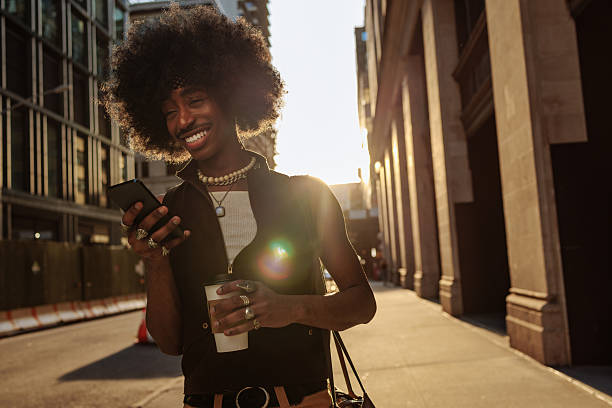 istock Laughing man checking phone on the streets 2230118452