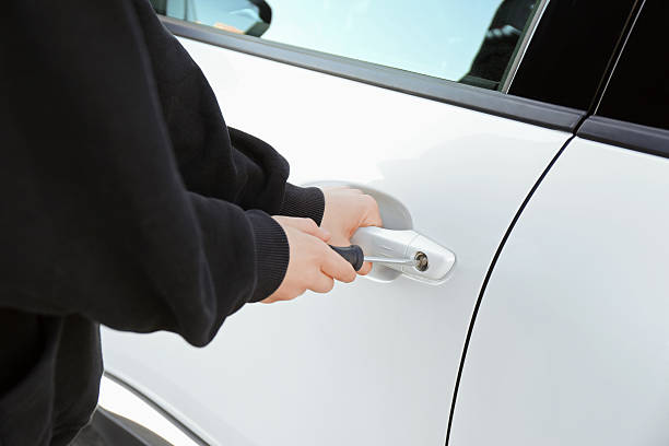 istock Thief with screwdriver breaking into car, closeup 2230118624