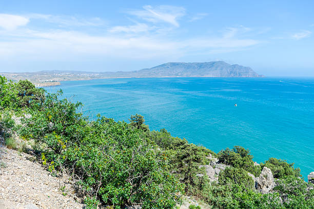istock Beautiful blue ocean with a green hillside 2230118870
