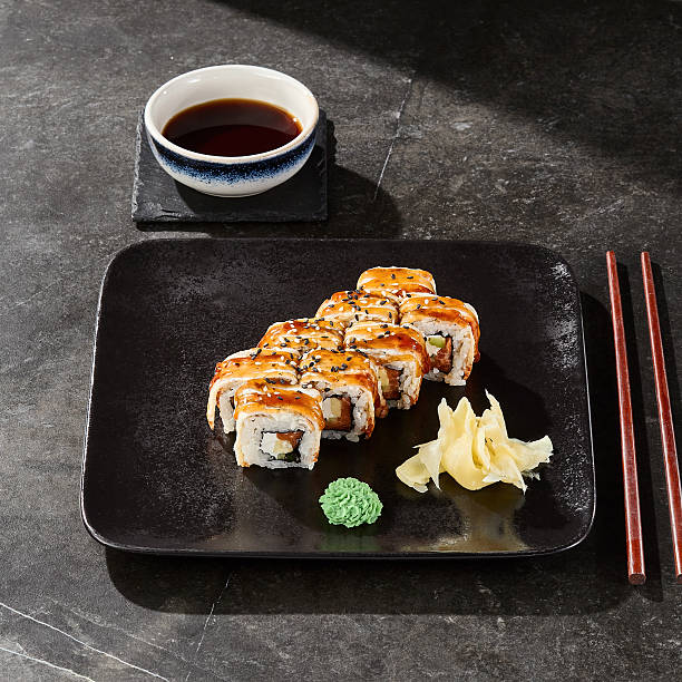 istock Unagi roll with avocado and salmon, bright lighting, overhead composition, on dark slate 2230119172