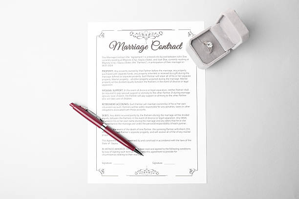 istock Marriage contract, pen and ring on grey table, top view 2230120263