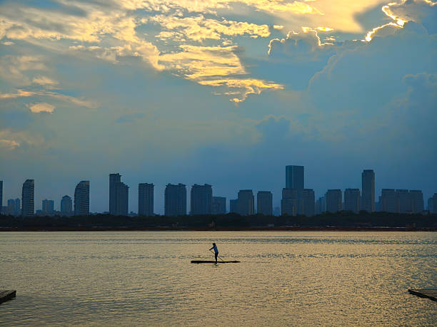 People boating on the city skyline in the evening