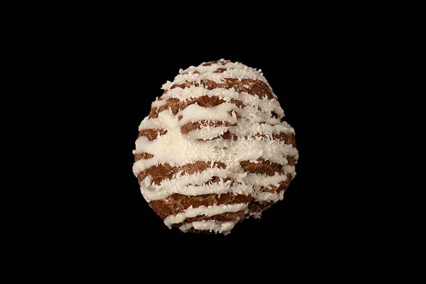 Profiteroles with coconut cream on a black background.