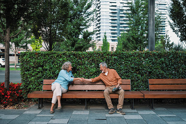 istock Two strangers meeting on a park bench 2230121677