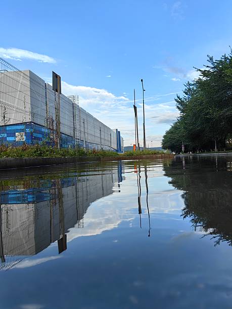 The sky and buildings reflect beautifully on the water's surface, creating a striking visual.