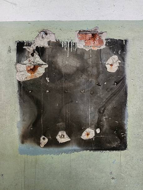 istock The aged wall reveals layers of texture, showing a square patch with peeling paint. 2230122152