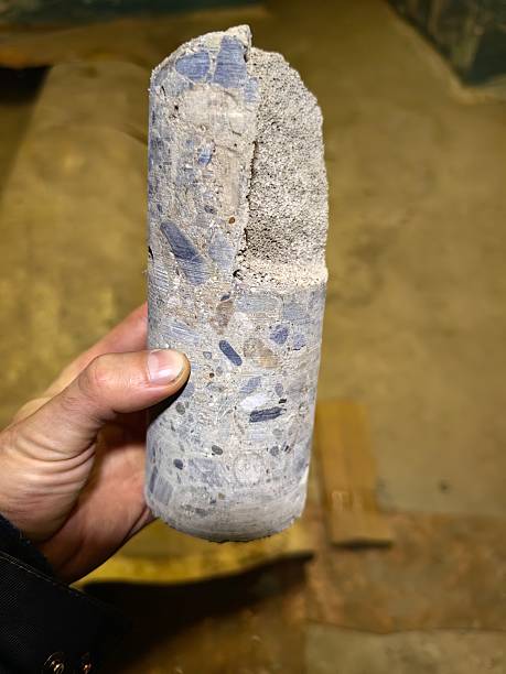 istock Concrete core sample held in a hand, revealing detailed aggregate composition and textures. 2230122157