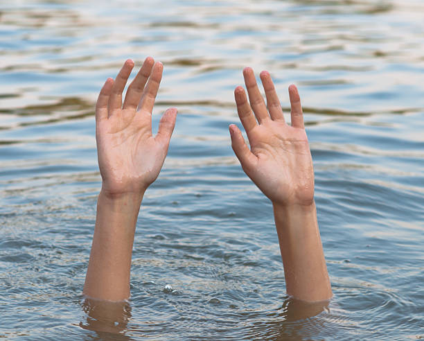 istock Young woman drowning in the river 2230122262