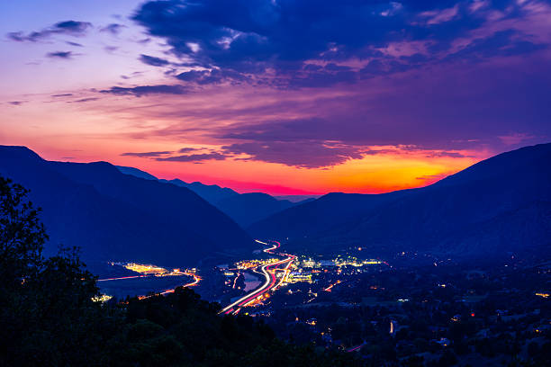 istock Mountain Valley Town at Dusk with Highway Light Trails 2230122451
