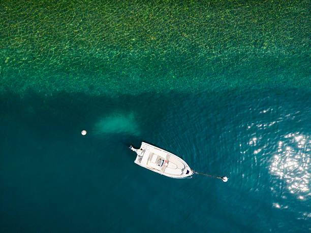 Aerial view on a single motorboat on the water at Lake Garda
