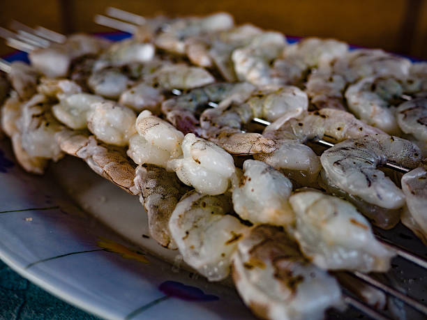 Cooking BBQ fresh prawns at camping. Grill fresh seafood for dinner.