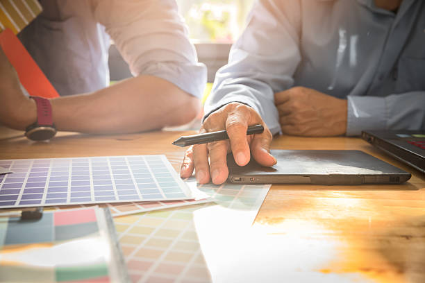 istock Interior designer chooses a color chart for home design. Graphic designers working on color chart at modern office. 2230126427
