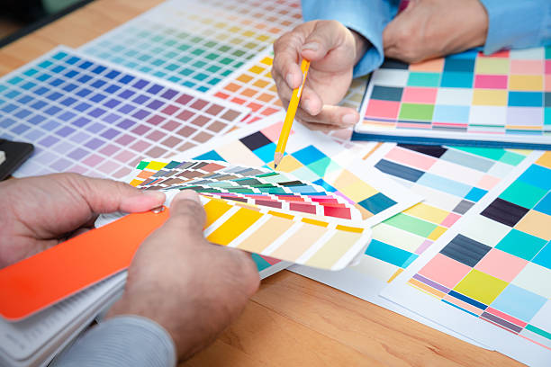 istock Interior designer chooses a color chart for home design. Graphic designers working on color chart at modern office. 2230126432
