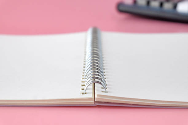 Soft focus a metal spiral binding of notebook on background.