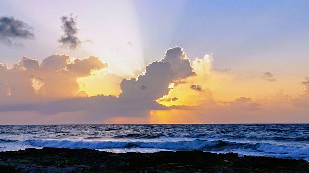 istock Sunrise in the Mexican Caribbean with dramatic cloud formations and visible sunbeams, Riviera Maya, Mexico 2230129921