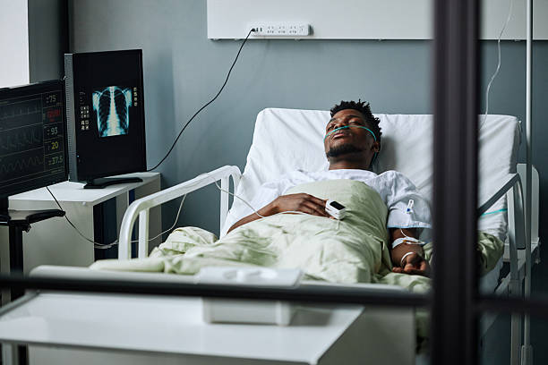 istock Young Black Man In Hospital Bed 2230130621