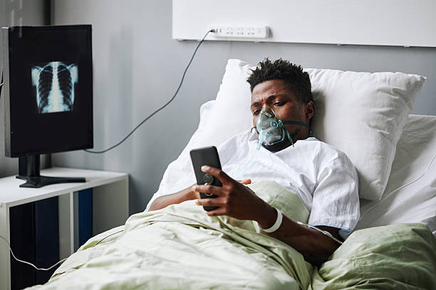 istock Black Man Surfing Internet In Hospital Ward 2230130837