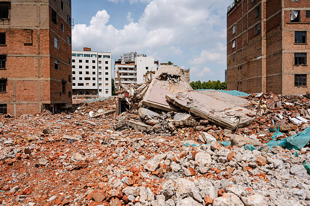 A photo of an urban demolition and reconstruction project. In the background, buildings are either about to be demolished or are currently being demolished, depicting the demolition of old buildings. Demolition of dilapidated homes makes way for new development.