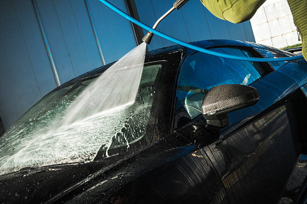 istock Cleaning a Sleek Black Car at a Car Wash Using a High-Pressure Spray Nozzle 2230133737