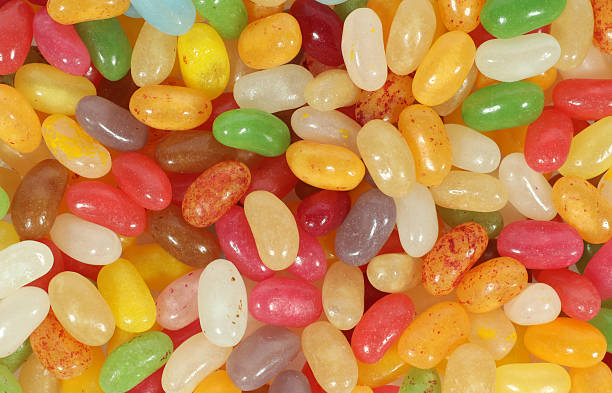 istock Delicious sweets jelly beans candies pile from above 2230136080
