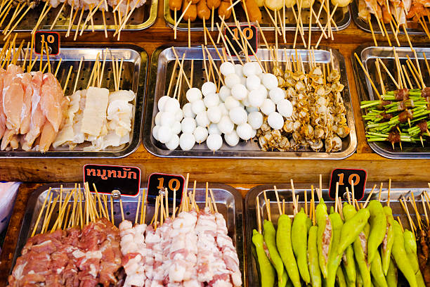 Plates with Thai barbecue food selection for 10 baht at night market