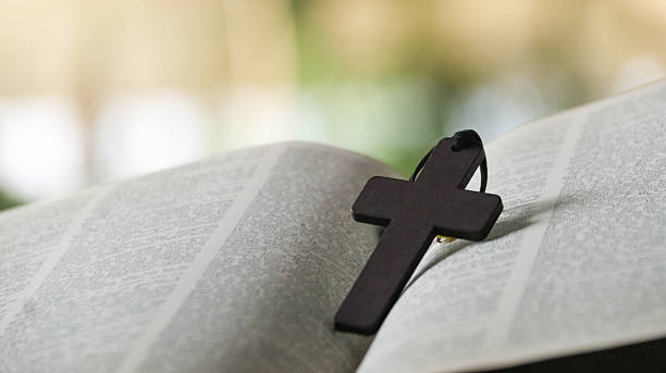 istock Wooden Jesus Cross on Old Book 2230136468