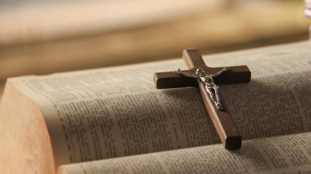 istock Wooden Jesus Cross on Old Book 2230136594
